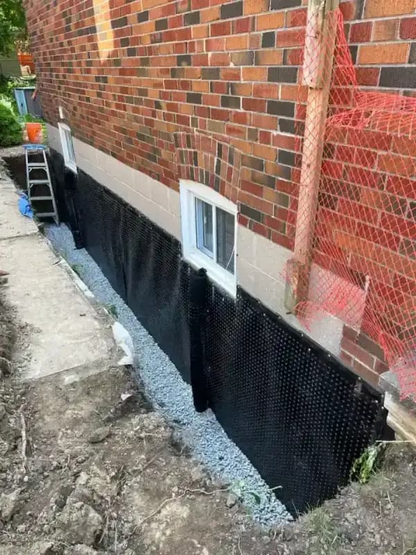 Exterior basement waterproofing work on a Toronto foundation